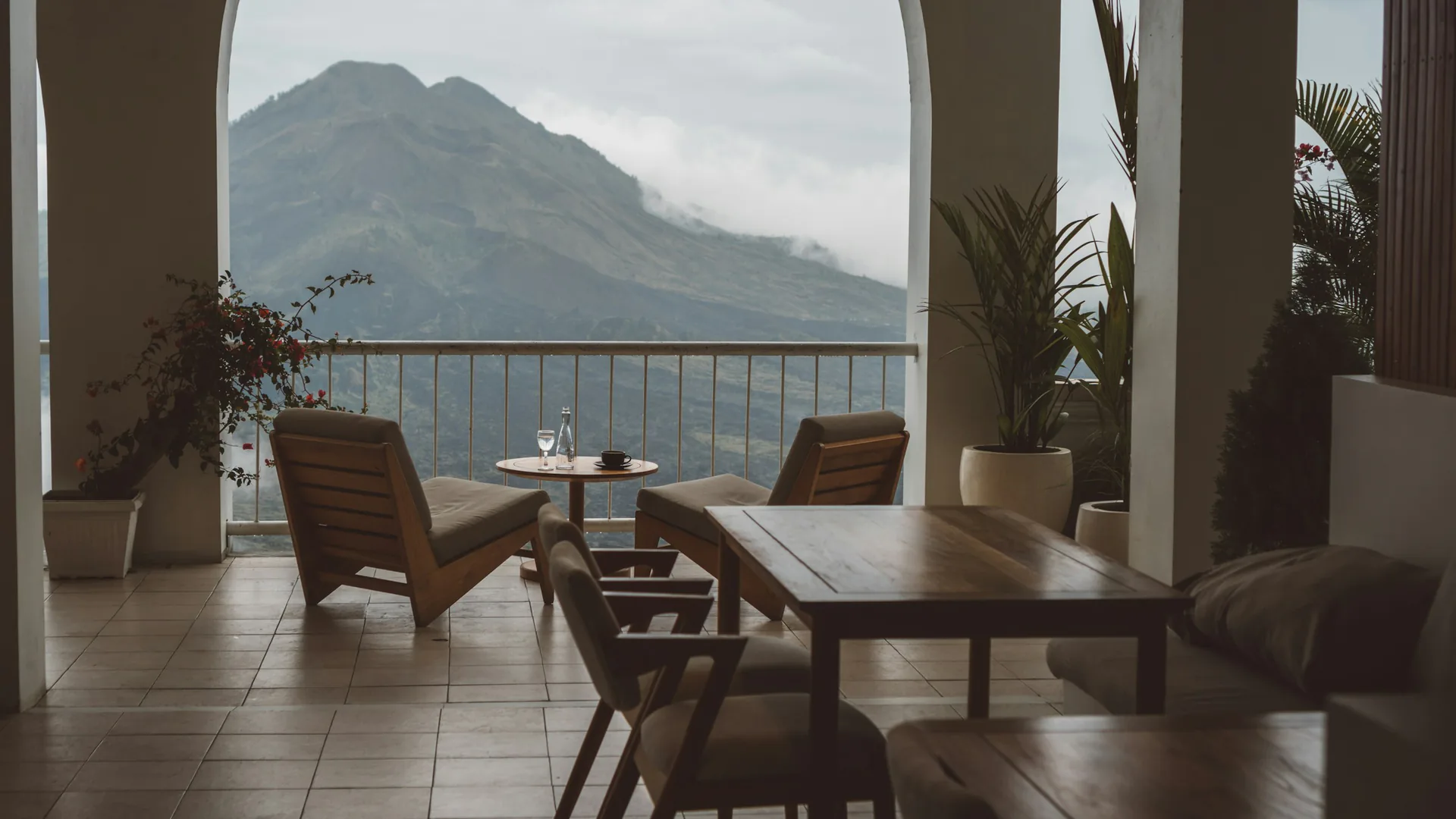 Teak dining set in an open Bali villa overlooking the mountains