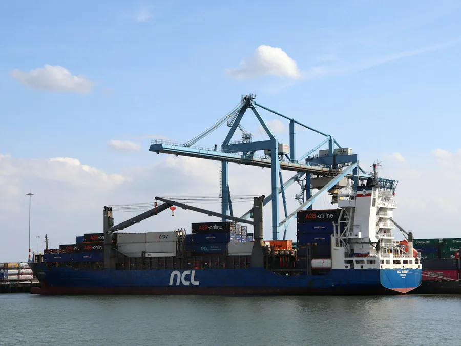 Container ship berthed under gantry cranes in Rotterdam