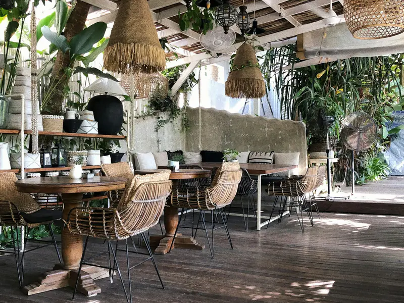 Rattan and teak furniture in an open-air Bali showroom