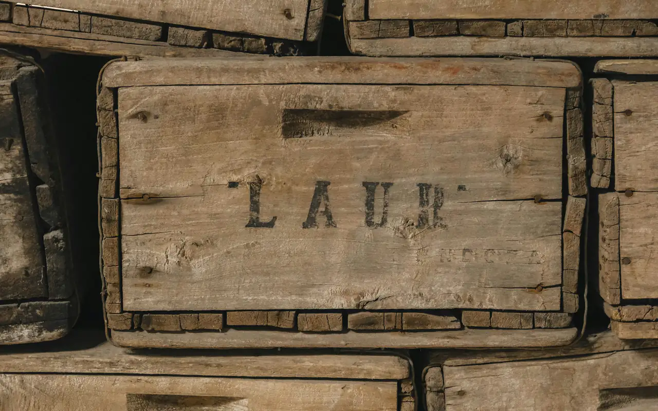 Weathered wooden crates with stencilled lettering, stacked tightly